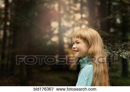 Stock Photo - Caucasian girl walking in forest. Fotosearch