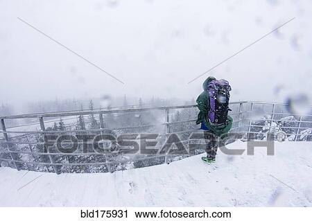 Stock Image - Caucasian hiker admiring scenic view. Fotosearch