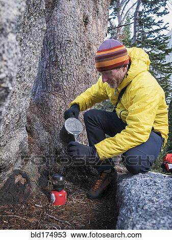 Caucasian hiker pouring coffee outdoors View Large Photo Image Stock Image - Caucasian hiker pouring coffee outdoors. Fotosearch