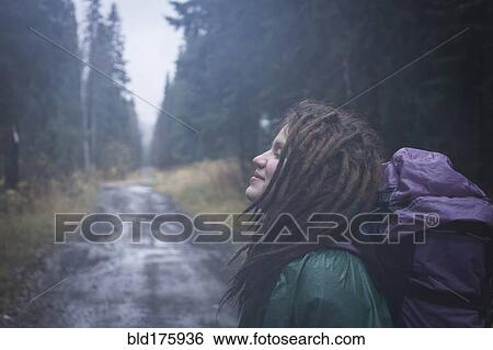 Caucasian hiker smiling on remote road View Large Photo Image Stock Photograph - Caucasian hiker smiling on remote road. Fotosearch