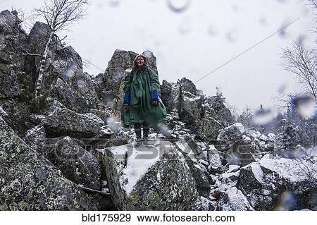 Stock Photo - Caucasian hiker standing on rocky hillside. Fotosearch