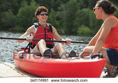 Caucasian instructor helping paraplegic woman with kayak View Large Photo Image Stock Image - Caucasian instructor helping paraplegic woman with kayak. Fotosearch