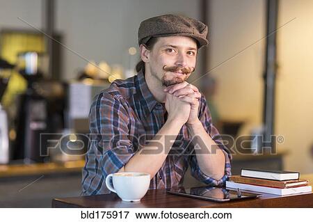 Caucasian man smiling in cafe View Large Photo Image Stock Photo - Caucasian man smiling in cafe. Fotosearch