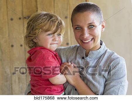 Caucasian mother and baby son smiling View Large Photo Image Stock Photo - Caucasian mother and baby son smiling. Fotosearch
