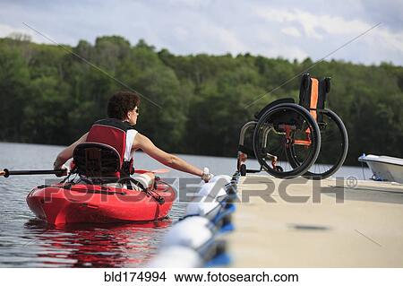Caucasian paraplegic woman rowing kayak View Large Photo Image Picture - Caucasian paraplegic woman rowing kayak. Fotosearch