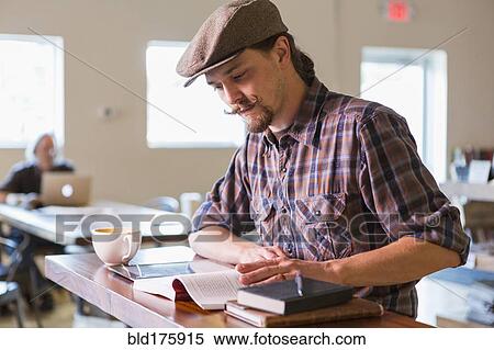 Caucasian student reading in cafe View Large Photo Image Stock Photography - Caucasian student reading in cafe. Fotosearch