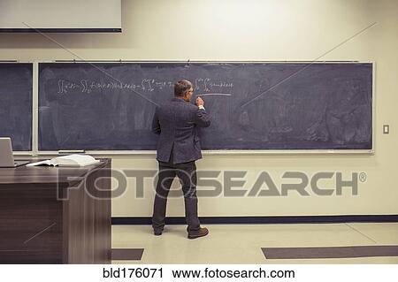 Caucasian teacher writing on chalkboard View Large Photo Image Stock Image - Caucasian teacher writing on chalkboard. Fotosearch