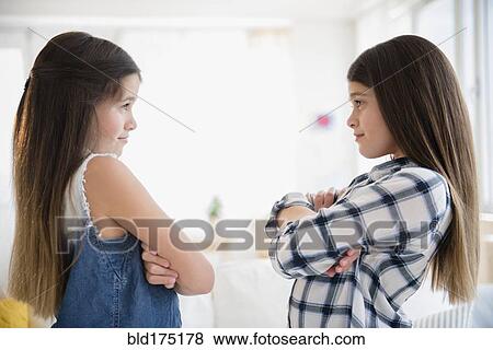 Stock Photo - Caucasian twin sisters arguing. Fotosearch