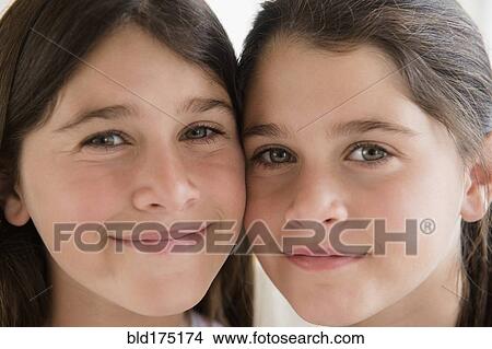 Caucasian twin sisters smiling View Large Photo Image Picture - Caucasian twin sisters smiling. Fotosearch