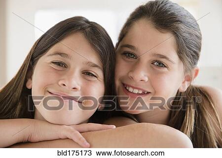 Caucasian twin sisters smiling View Large Photo Image Stock Image - Caucasian twin sisters smiling. Fotosearch