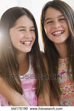 Caucasian twin sisters smiling View Large Photo Image Stock Image - Caucasian twin sisters smiling. Fotosearch