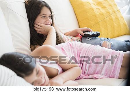Caucasian twin sisters watching television View Large Photo Image Stock Image - Caucasian twin sisters watching television. Fotosearch