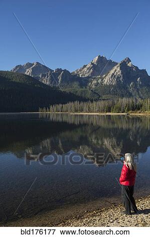 Caucasian woman admiring mountain and lake View Large Photo Image Stock Photo - Caucasian woman admiring mountain and lake. Fotosearch