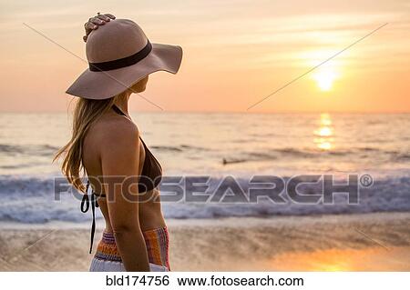 Caucasian woman admiring sunset and ocean View Large Photo Image Stock Photograph - Caucasian woman admiring sunset and ocean. Fotosearch
