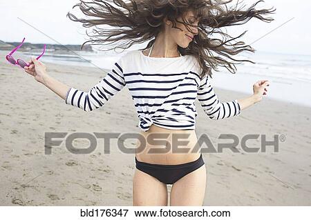 Caucasian woman dancing on beach View Large Photo Image Stock Photo - Caucasian woman dancing on beach. Fotosearch