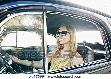 Caucasian woman driving vintage car View Large Photo Image Picture - Caucasian woman driving vintage car. Fotosearch