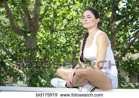 Stock Photo - Caucasian woman meditating outdoors. Fotosearch