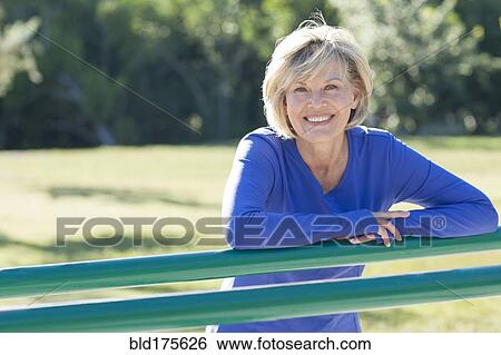 Caucasian woman smiling in park View Large Photo Image Stock Photograph - Caucasian woman smiling in park. Fotosearch