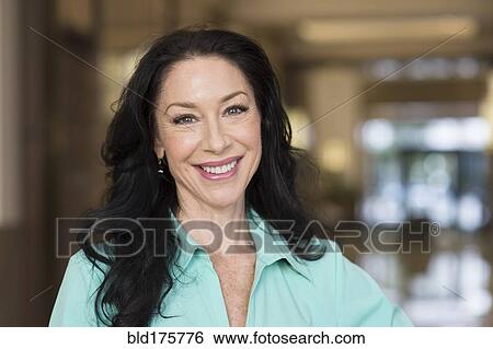 Stock Photograph - Caucasian woman smiling indoors. Fotosearch