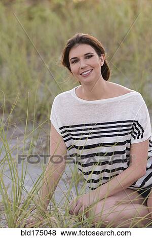 Caucasian woman smiling on beach View Large Photo Image Stock Photo - Caucasian woman smiling on beach. Fotosearch