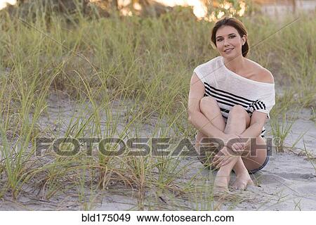 Stock Photo - Caucasian woman smiling on beach. Fotosearch