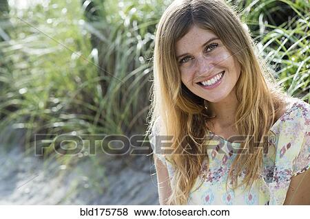 Stock Photo - Caucasian woman smiling on beach. Fotosearch