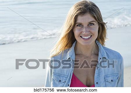 Caucasian woman smiling on beach View Large Photo Image Stock Photograph - Caucasian woman smiling on beach. Fotosearch