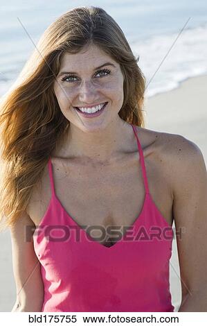 Stock Photography - Caucasian woman smiling on beach. Fotosearch