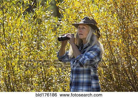 Caucasian woman using binoculars View Large Photo Image Stock Photograph - Caucasian woman using binoculars. Fotosearch