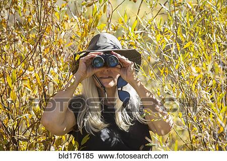 Caucasian woman using binoculars View Large Photo Image Stock Photography - Caucasian woman using binoculars. Fotosearch