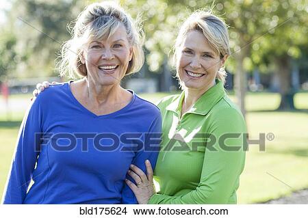Caucasian women smiling in park View Large Photo Image Picture - Caucasian women smiling in park. Fotosearch