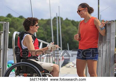 Picture - Caucasian women talking at marina. Fotosearch