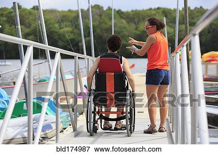 Stock Photo - Caucasian women talking at marina. Fotosearch