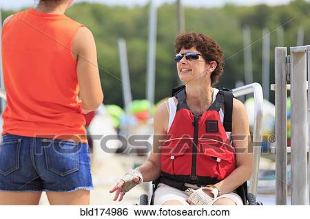 Caucasian women talking at marina View Large Photo Image Stock Photograph - Caucasian women talking at marina. Fotosearch
