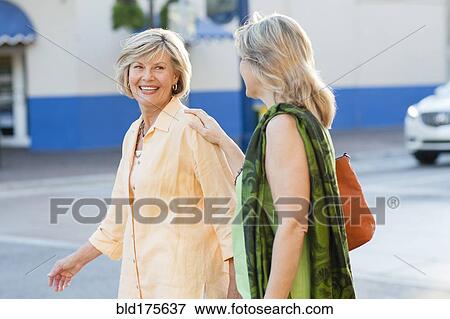 Caucasian women walking in city View Large Photo Image Stock Photo - Caucasian women walking in city. Fotosearch