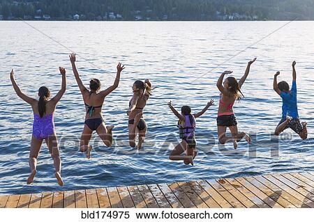 Stock Photography - Children jumping into lake. Fotosearch
