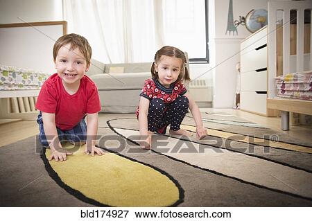 Stock Photo - Children playing on floor in bedroom. Fotosearch