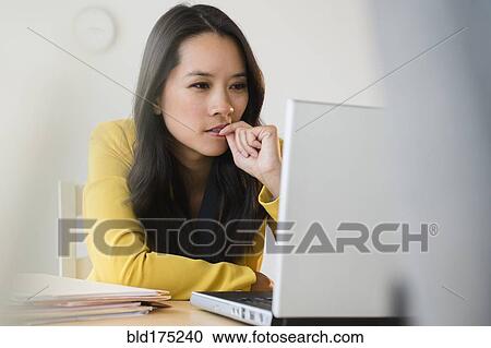 Chinese businesswoman using laptop View Large Photo Image Stock Image - Chinese businesswoman using laptop. Fotosearch
