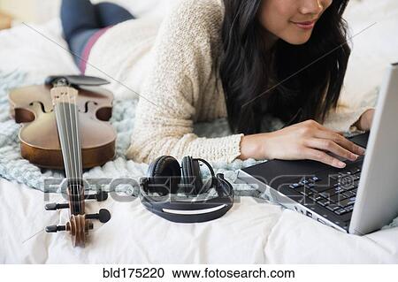 Stock Image - Chinese musician using laptop. Fotosearch