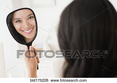 Chinese woman admiring herself in mirror View Large Photo Image Stock Photograph - Chinese woman admiring herself in mirror. Fotosearch