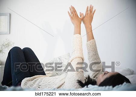 Stock Image - Chinese woman making shadow puppet. Fotosearch