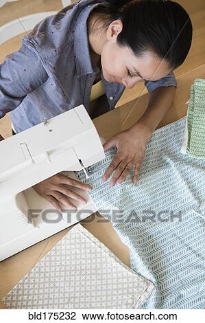Chinese woman using sewing machine View Large Photo Image Stock Image - Chinese woman using sewing machine. Fotosearch
