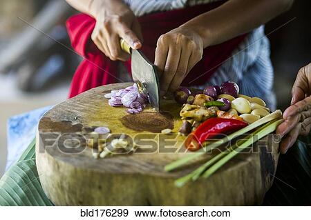 Close up of chefs chopping vegetables on cutting board View Large Photo Image Stock Photo - Close up of chefs chopping vegetables on cutting board. Fotosearch