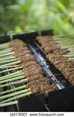 Stock Image - Close up of food cooking on grill outdoors. Fotosearch