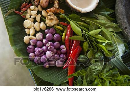 Stock Photograph - Close up of fresh produce and herbs on counter. Fotosearch