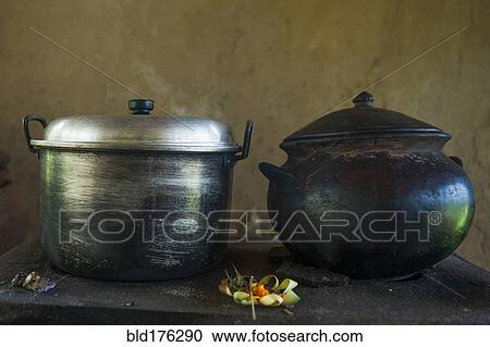 Stock Image - Close up of iron and steel pots on kitchen counter. Fotosearch
