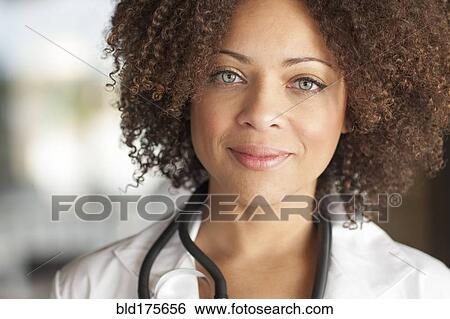 Stock Photograph - Close up of mixed race doctor smiling. Fotosearch