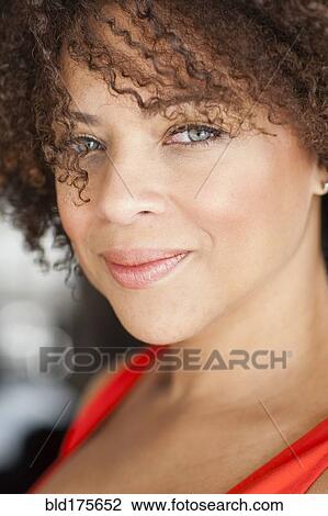 Stock Image - Close up of mixed race woman smiling. Fotosearch