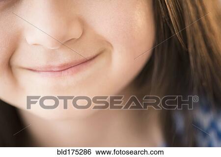 Stock Photograph - Close up of mouth of smiling girl. Fotosearch