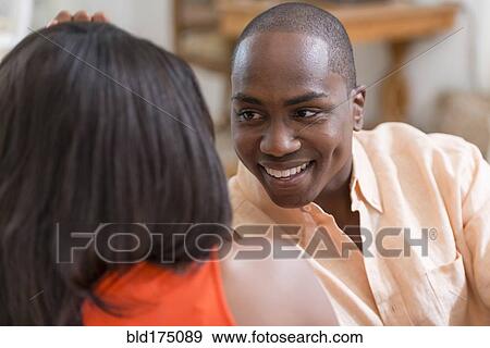 Stock Photo - Couple talking on sofa. Fotosearch